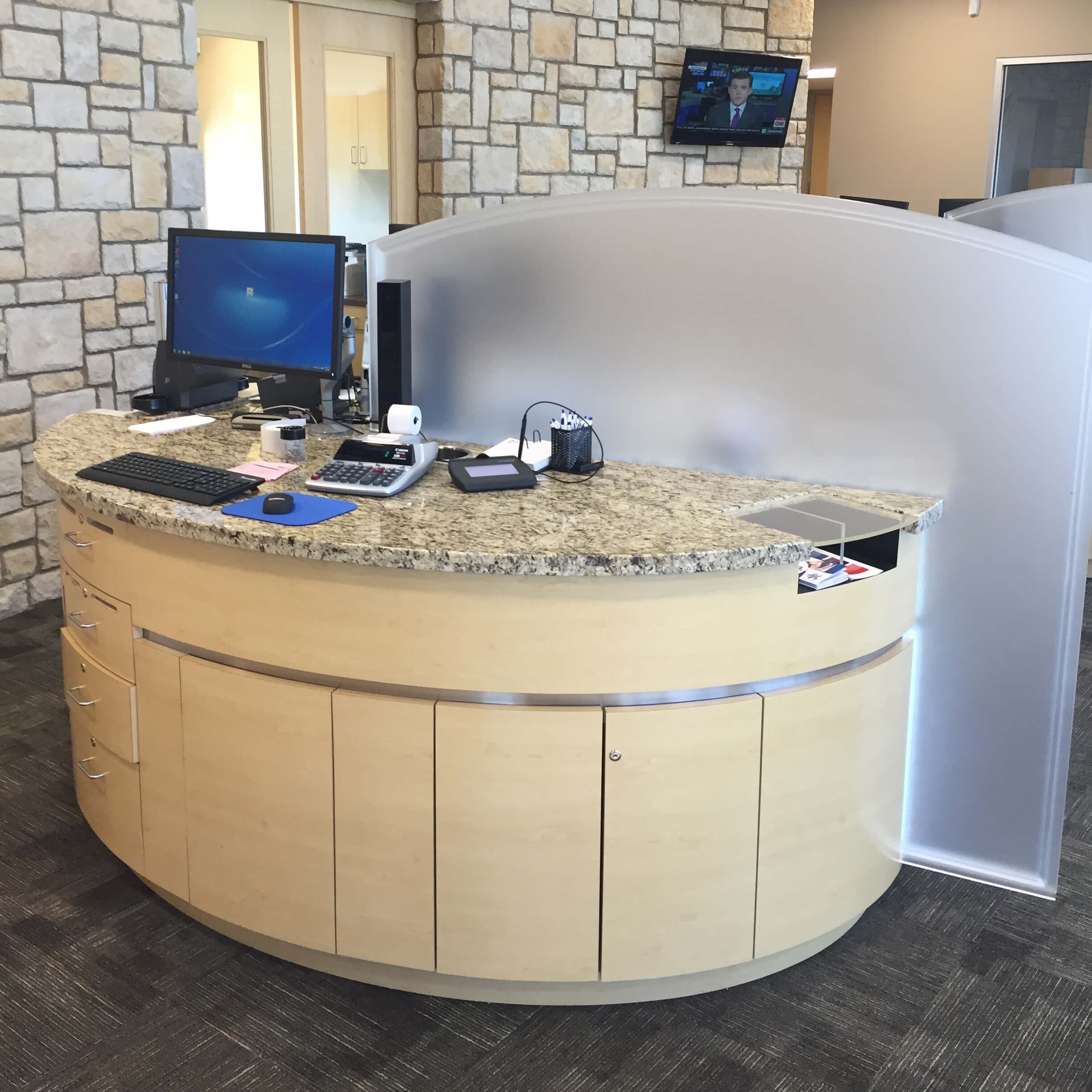 Finished commercial reception counter fabricated by Granite Division