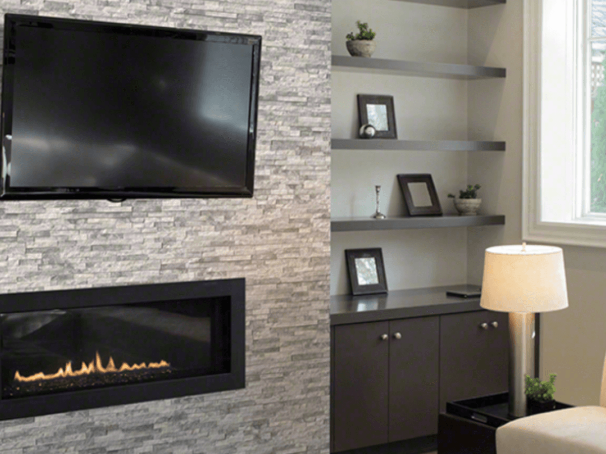Finished stacked-stone fireplace surround with built-in shelving