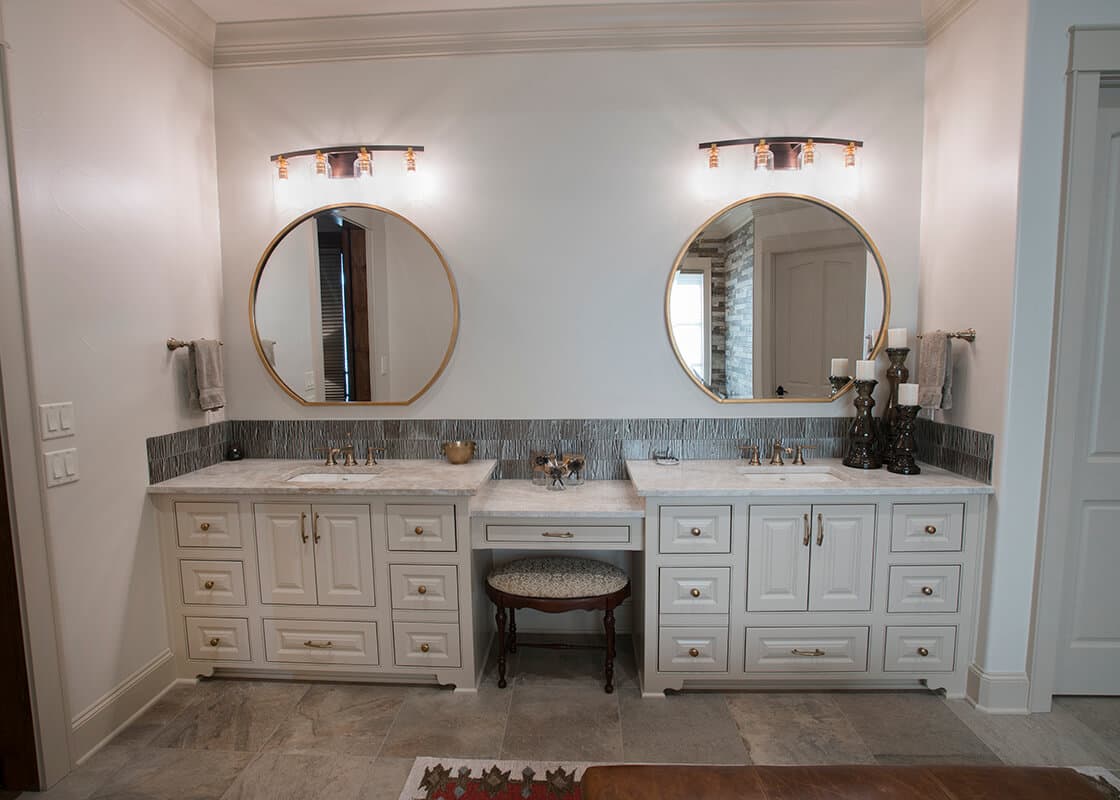 Finished double vanity with pale stone tops and coordinated splash