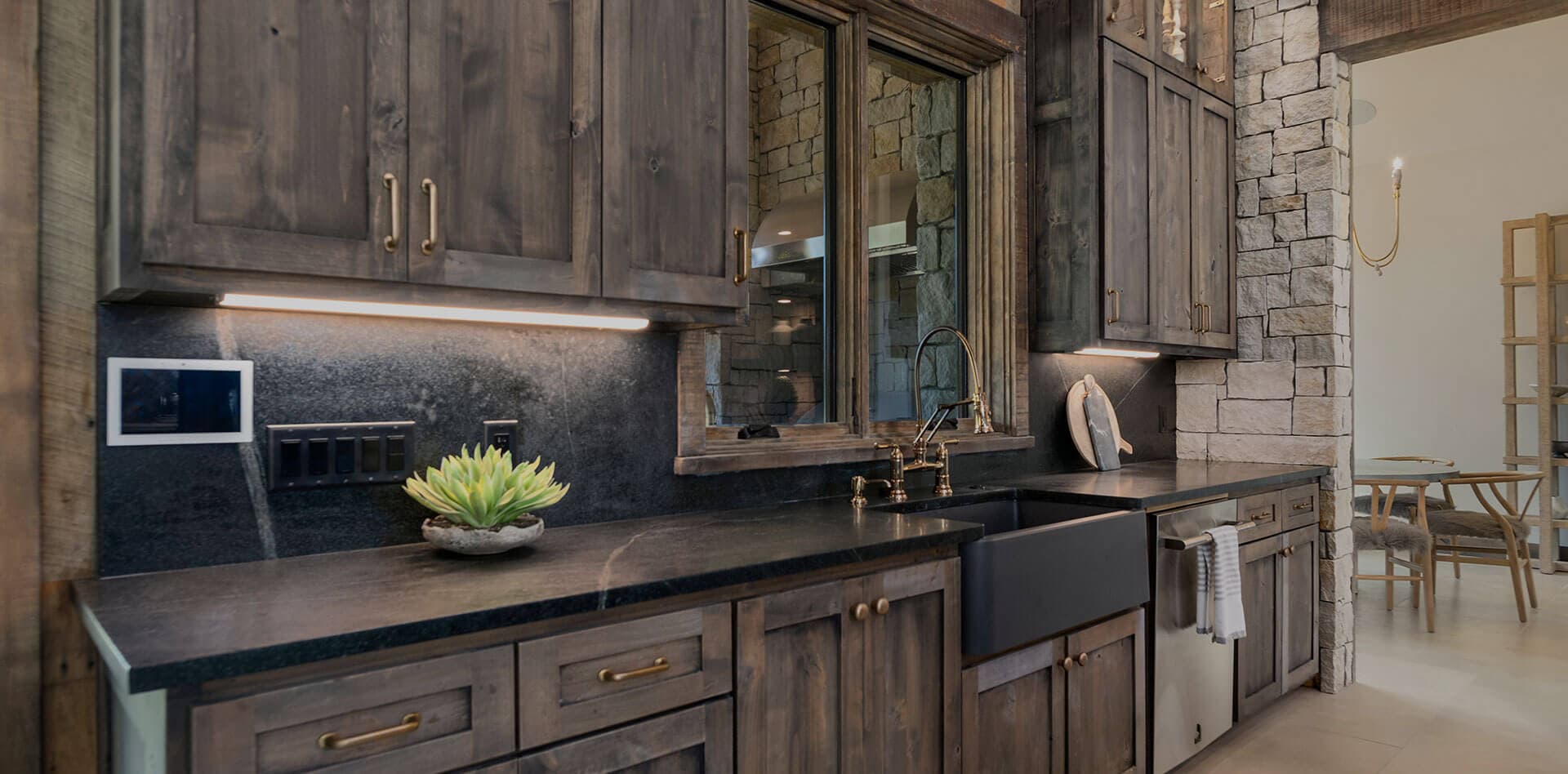 Finished kitchen with a light stone counter and coordinated backsplash behind the range