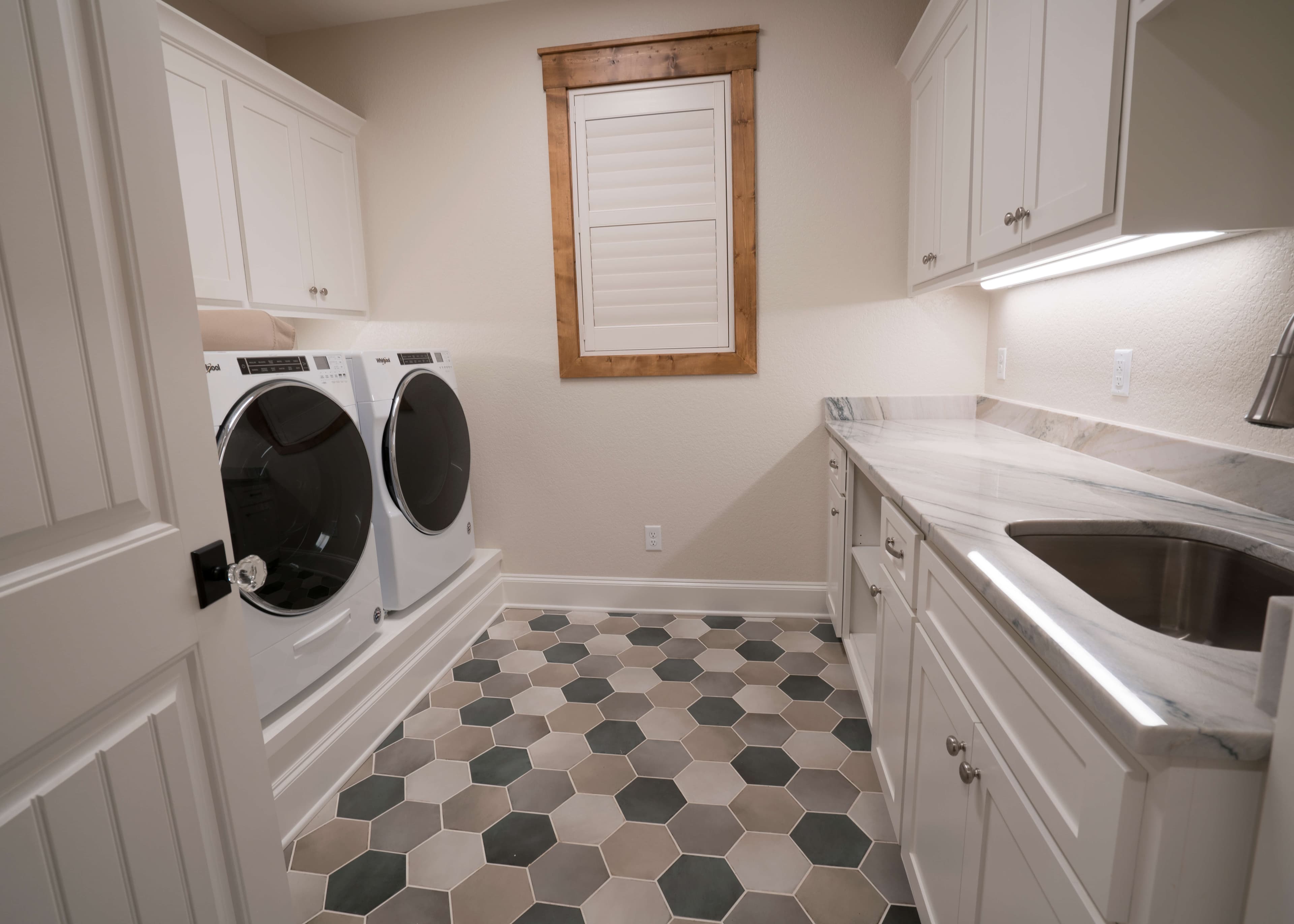 Finished utility room with a multicolor hex tile floor